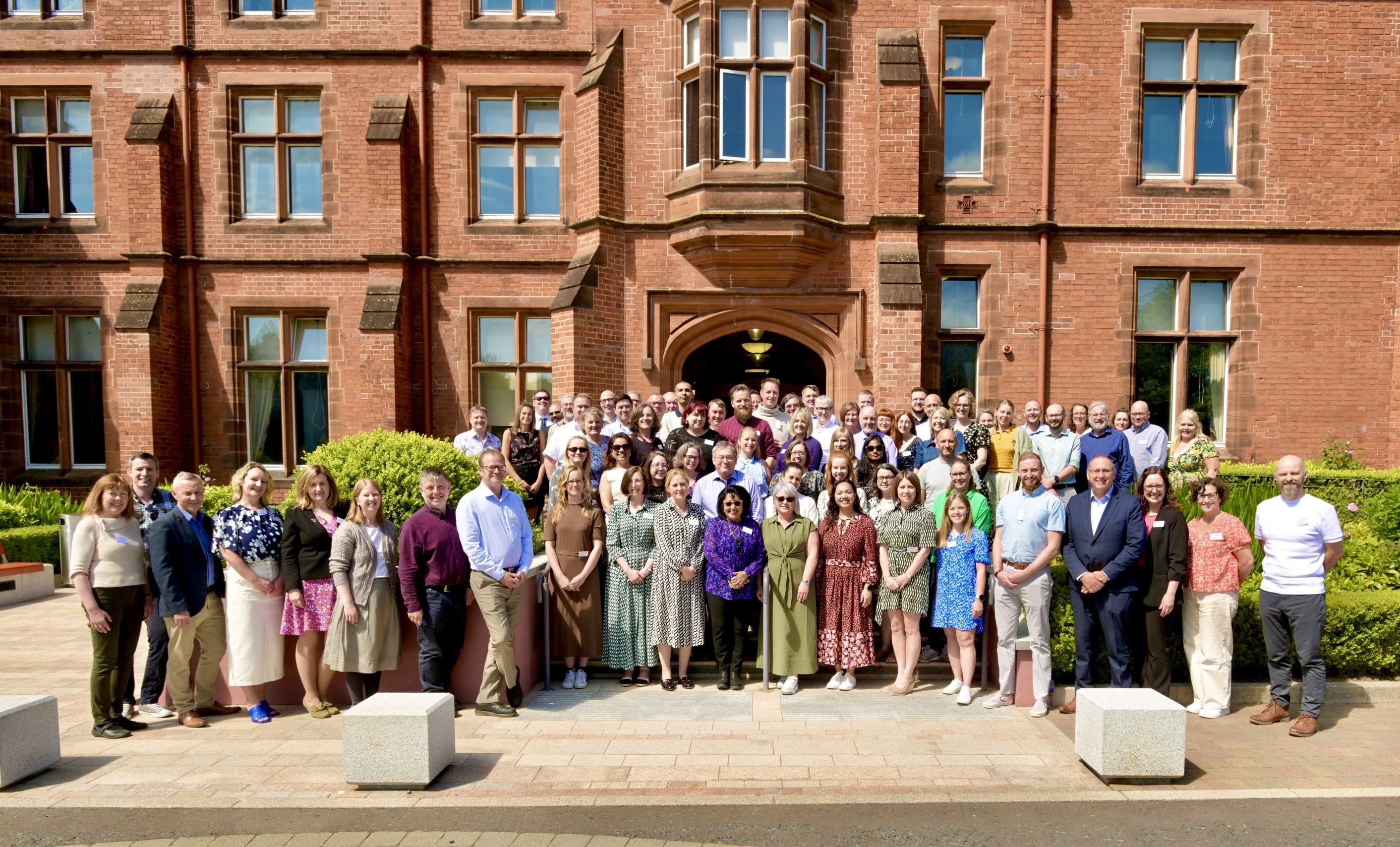 Delegates stand outside Riddel Hall