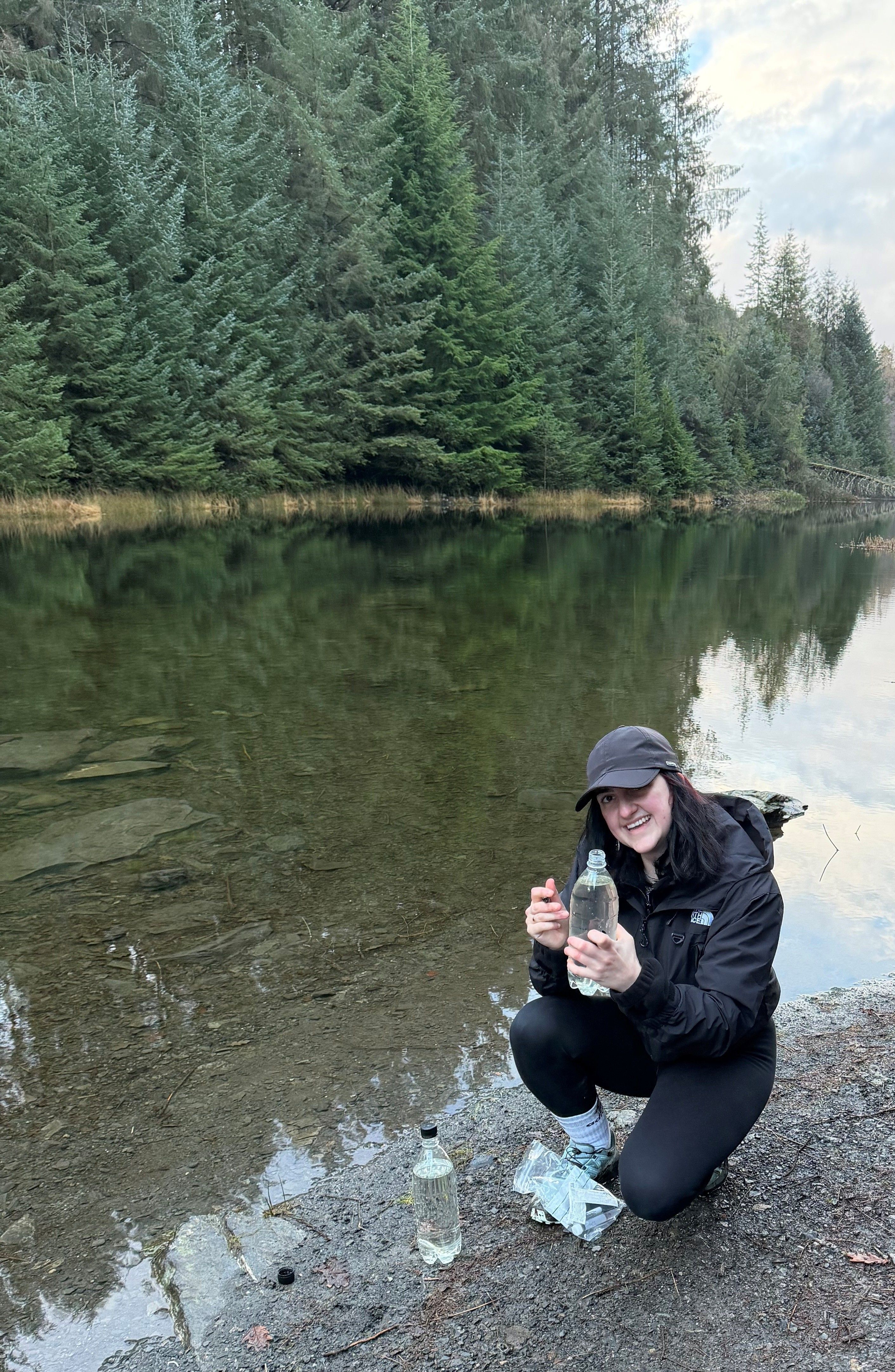 Dr Jessica Pimlott, Technical Specialist in Electrochemistry at Manchester Metropolitan University collecting water samples in Eryri national park to use in her research concerning the development and testing of sensors for water quality monitoring