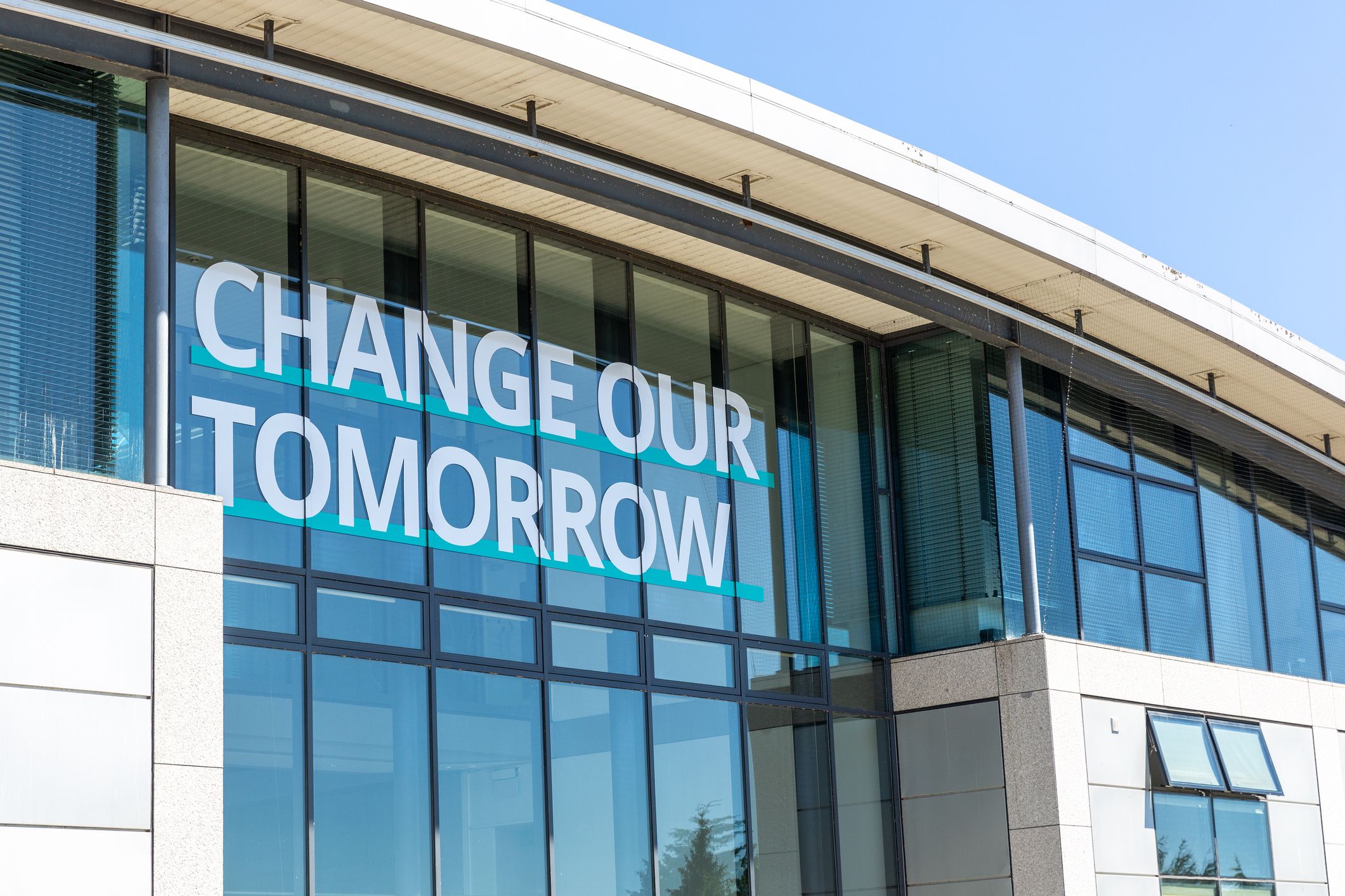 Campus building with the words 'Change Our Tomorrow' on the external window