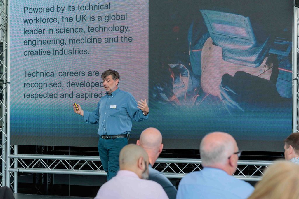 Dr Simon Breeden presents a slide with the words 'Powered by its technical workforce, the UK is a global leader in science, technology, engineering, medicine and the creative industries. Technical careers are recognised, developed, respected and aspired to.'