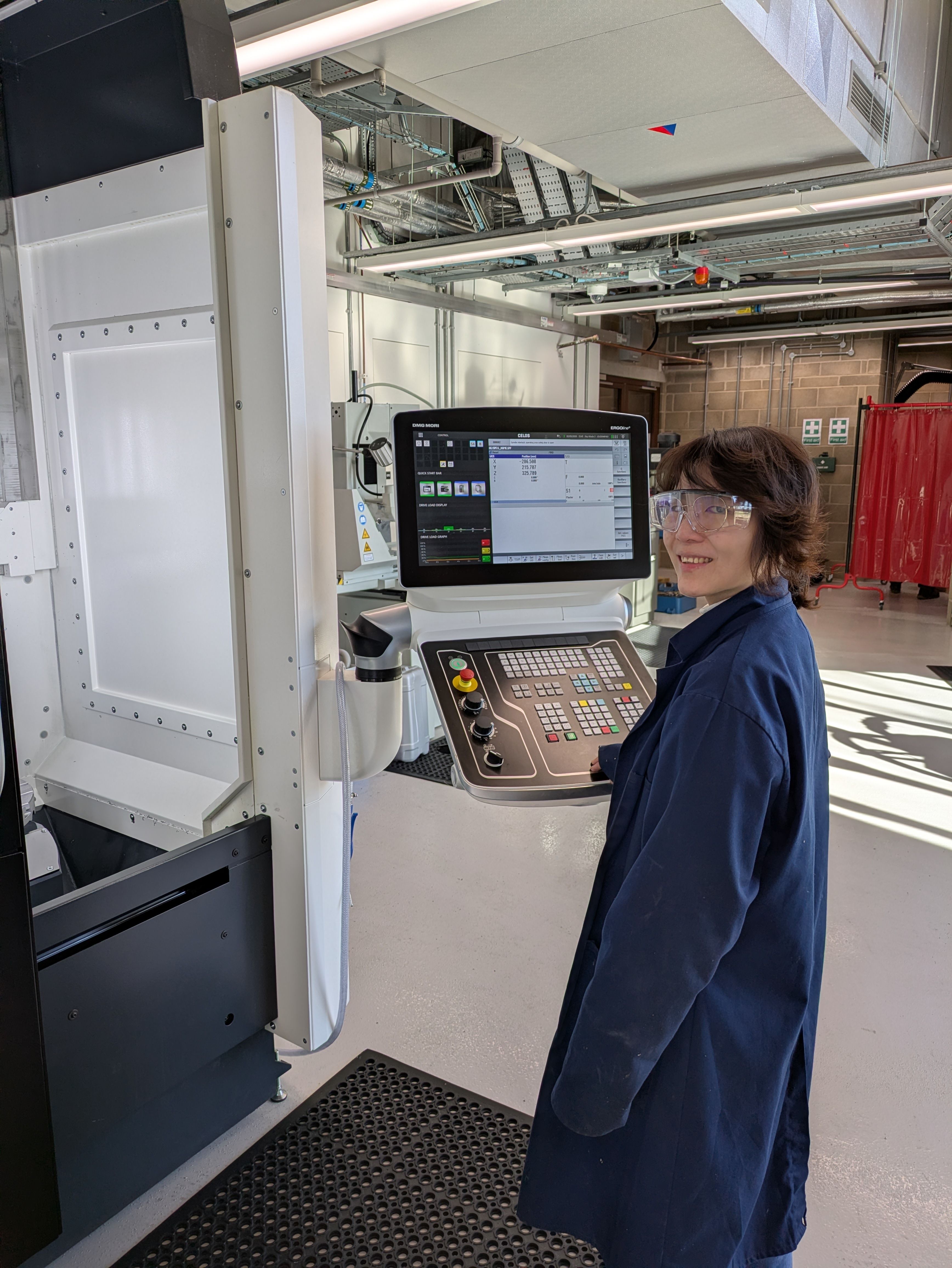 Mai Doan, Workshop Manufacturing Engineer based at the Precision Fabrication Workshop at UCL EAST ,  operating the 5 Axis CNC.